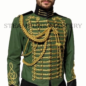May include: Green military-style jacket with gold-colored embellishments, including buttons, trim, and a decorative rope. The jacket has a high collar and black accents on the cuffs. The text "STEAM PUNK MASTERY" is visible on the jacket.