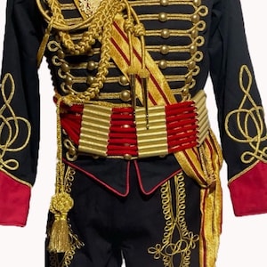 May include: A black military uniform with gold braid and buttons, a red sash, and a gold belt. The uniform has a high collar and long sleeves.