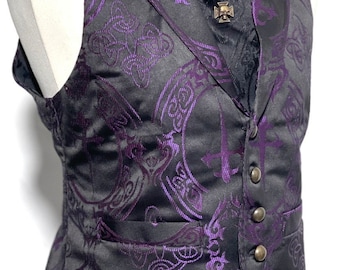 May include: A black waistcoat with a purple paisley pattern and a black cravat. The waistcoat has a button closure and a pocket on the left side.