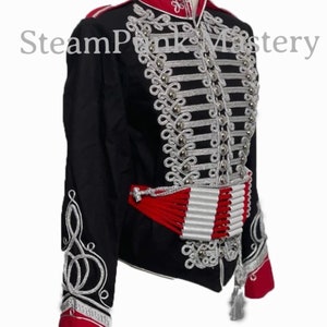May include: A black jacket with silver and red trim. The jacket has a high collar and a row of buttons down the front. The sleeves have silver trim and the cuffs are red. The jacket is a steampunk style.