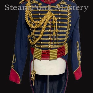May include: A blue and red military-style jacket with gold trim and buttons. The jacket has a high collar and a long tail. The jacket is decorated with gold braid and a gold belt with red accents.