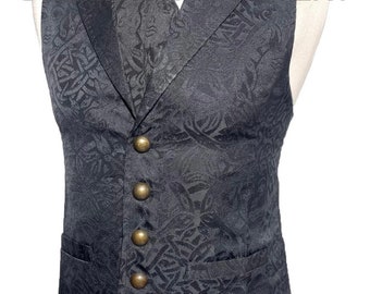 May include: A black patterned vest with a high collar and gold buttons. The vest has a pocket on the left side.