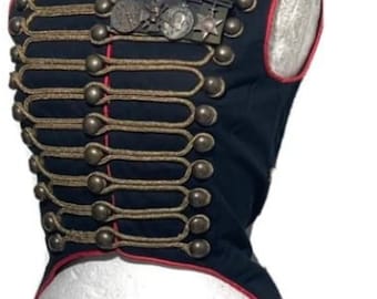 May include: A black and red steampunk-style vest with gold trim and buttons. The vest has a long tail and is decorated with a row of buttons down the front. The vest is on a white mannequin.