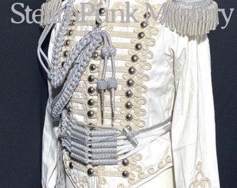May include: A white military-style jacket with gold and silver trim. The jacket has a high collar, long sleeves, and a button-up front. The jacket is decorated with a variety of embellishments, including braid, buttons, and tassels.
