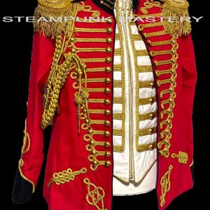 May include: A red military-style jacket with gold embellishments, including epaulets, trim, and buttons. The jacket features a black collar and cuffs, and a white vest with gold trim is visible beneath. The text "STEAMPUNK MASTERY" is visible.