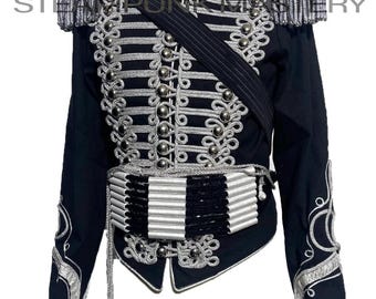 May include: Black military-style jacket with silver embroidery and accents. Features include epaulets, decorative buttons, and a sash. The jacket has a high collar and intricate detailing, suitable for cosplay or themed events.