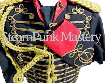 May include: A black military-style jacket with gold trim and buttons. The jacket has a red collar and cuffs. The jacket is decorated with gold braid and a gold cord.