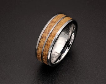 May include: A silver ring with a wood inlay. The wood has a brown and tan pattern. The ring is about 8mm wide.