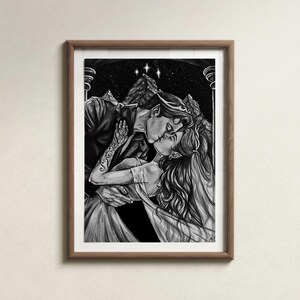 May include: Monochrome framed art print showing a couple kissing. The image features a man and woman in an embrace, with a backdrop of a starry sky and mountains. The artwork is detailed, focusing on the figures' expressions and attire.