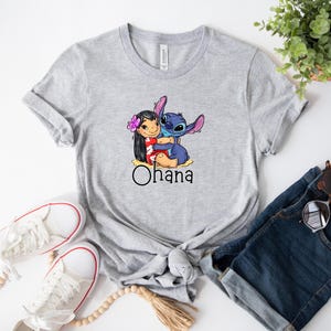 May include: Gray t-shirt with a cartoon image of Stitch and Lilo hugging. The text "Ohana" is printed below the image.