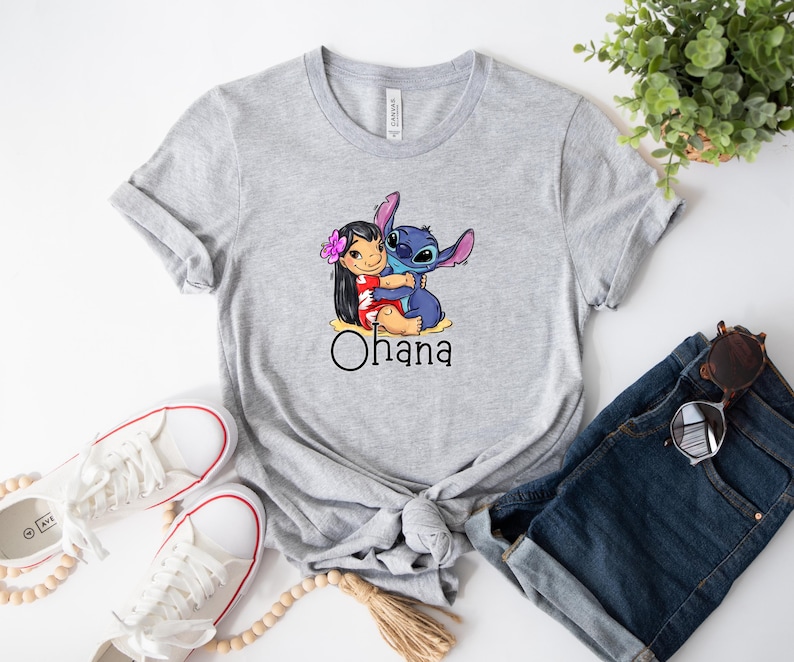 May include: Gray t-shirt with a cartoon image of Stitch and Lilo hugging. The text "Ohana" is printed below the image.