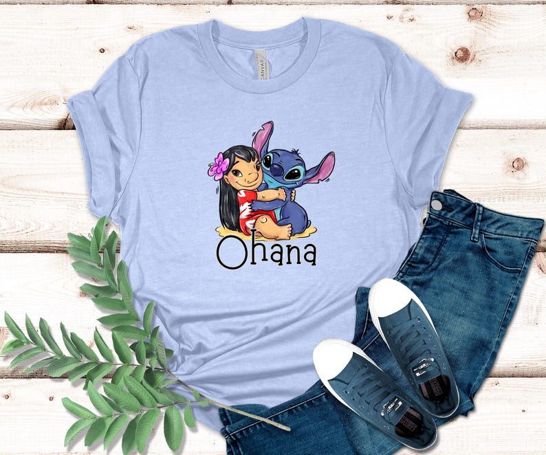 May include: Light blue t-shirt with a graphic of Stitch and Lilo hugging. The text "Ohana" is printed below the image.