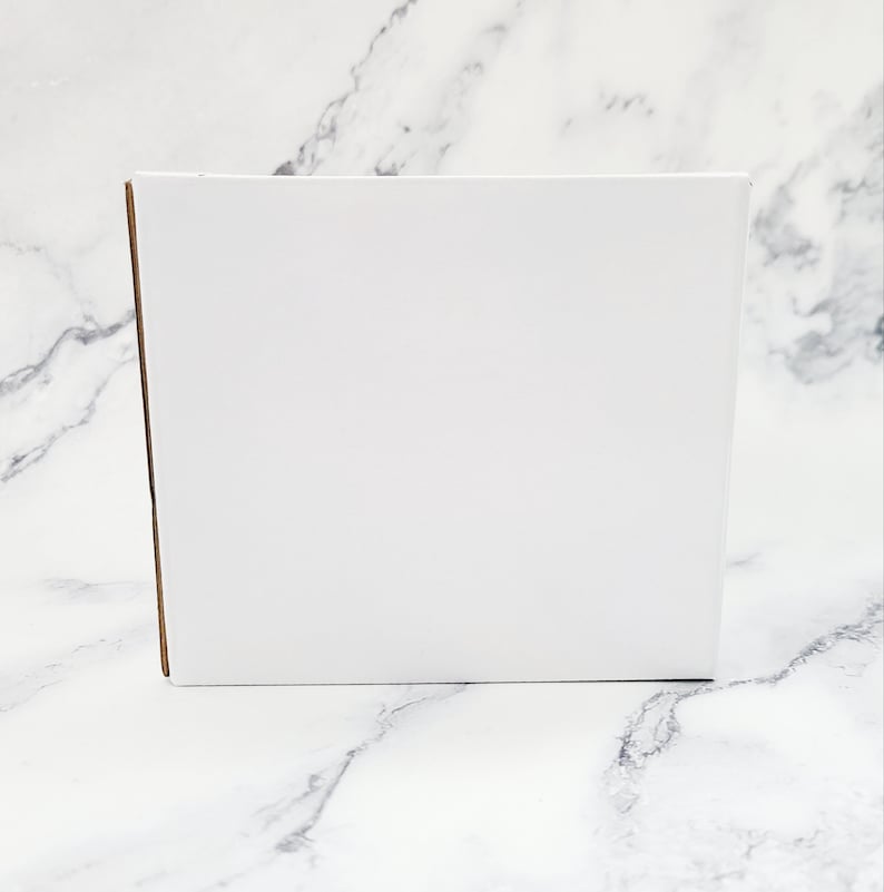 May include: A white cardboard box with a brown edge.