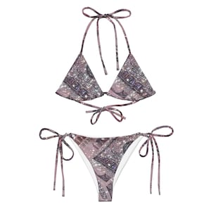 May include: A pink and white bikini with a glittery dollar bill print. The bikini top is a triangle style with adjustable straps and ties at the back. The bikini bottom is a cheeky style with ties on the sides.