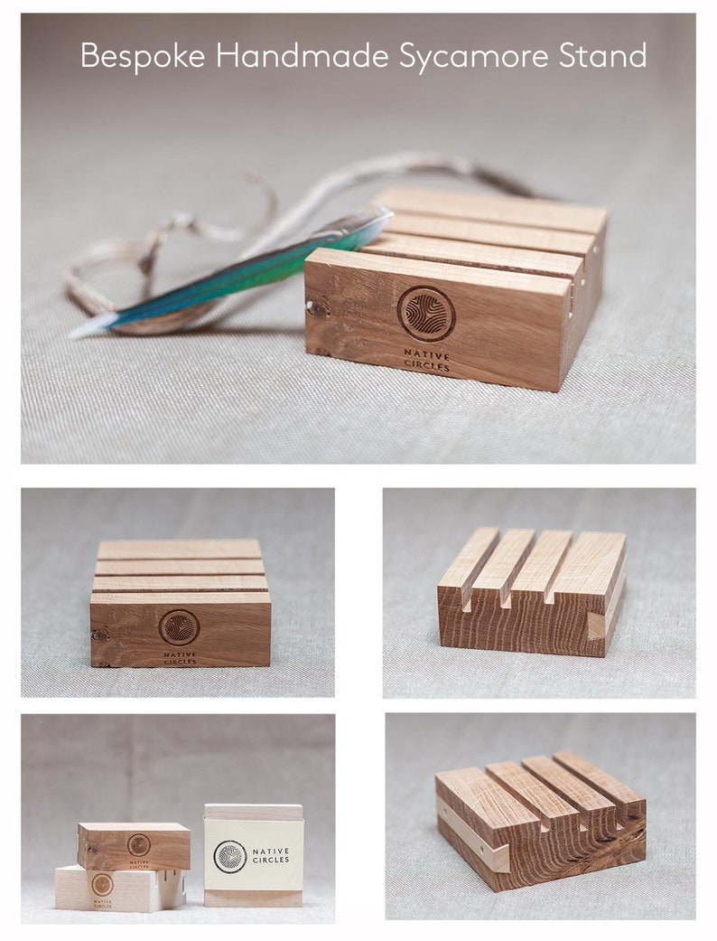 May include: A wooden stand made of sycamore wood with a Native Circles logo. The stand has four sides and is designed to hold items like jewelry or other small objects. The stand is made of natural wood and has a rustic look.