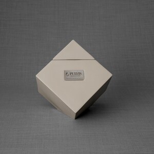 Ceramic art urn for ashes Abstract. The urn represents a cube sitting on one of its angles. The top angle pyramid is removable and there is a small place for a candle. This is a photo of all the available colors. Cube Urn for Ashes. Cube Urn