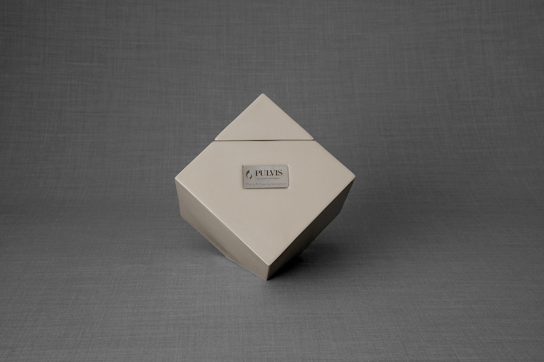 Ceramic art urn for ashes Abstract. The urn represents a cube sitting on one of its angles. The top angle pyramid is removable and there is a small place for a candle. This is a photo of all the available colors. Cube Urn for Ashes. Cube Urn