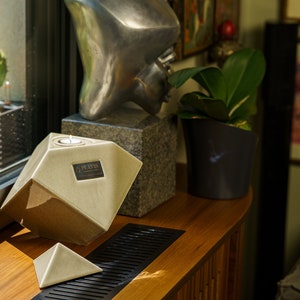 Ceramic art urn for ashes Abstract. The urn represents a cube sitting on one of its angles. The top angle pyramid is removable and there is a small place for a candle. This is a photo of all the available colors. Cube Urn for Ashes. Cube Urn