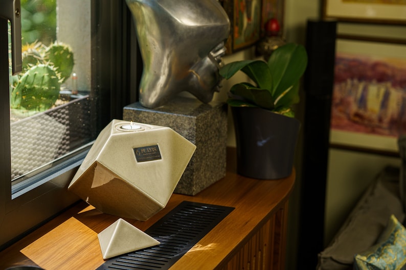 Ceramic art urn for ashes Abstract. The urn represents a cube sitting on one of its angles. The top angle pyramid is removable and there is a small place for a candle. This is a photo of all the available colors. Cube Urn for Ashes. Cube Urn