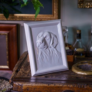 Labrador Retriever Pet Urn for Ashes. This beautiful picture frame portrait urn of a labrador retriever is a unique memorial for a lab dog. Handmade from ceramic, this pet urn for labrador is the ideal resting place for a loved friend. By Pulvis Art