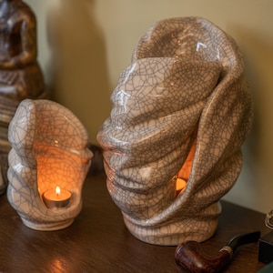 Handmade adult urn for cremation ashes Light. The urn has a place for a candle in the middle or an option for putting flowers. The capacity of 237 cubic inches. Ashes go inside the walls. This is a photo of a large urn and keepsake.