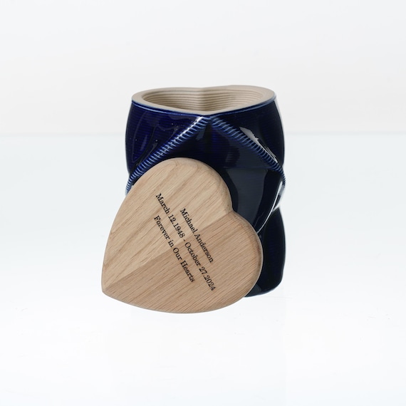 A personalized 3D-printed ceramic cremation keepsake urn with a wooden lid — a genuinely thoughtful, tech-meets-craft memorial object that solves a real emotional need.