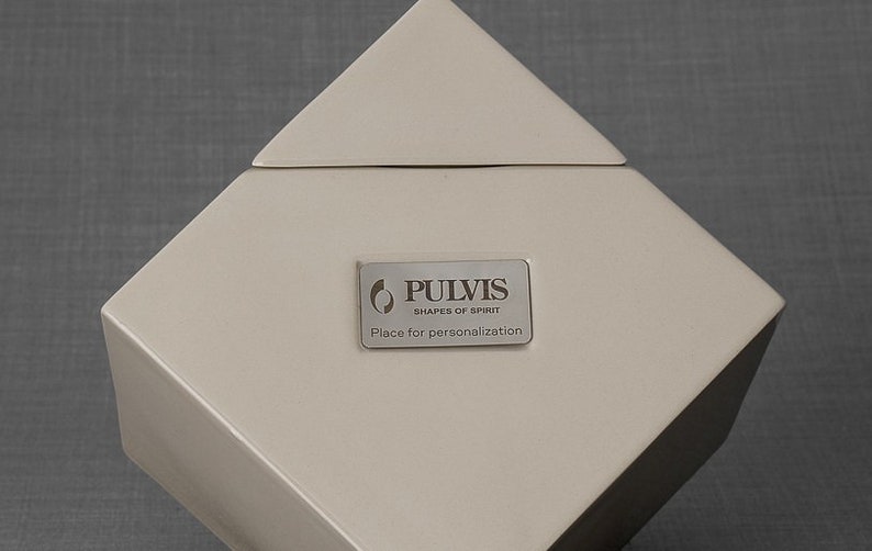Ceramic art urn for ashes Abstract. The urn represents a cube sitting on one of its angles. The top angle pyramid is removable and there is a small place for a candle. This is a photo of all the available colors. Cube Urn for Ashes. Cube Urn