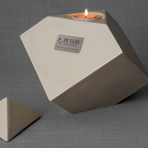 Ceramic art urn for ashes Abstract. The urn represents a cube sitting on one of its angles. The top angle pyramid is removable and there is a small place for a candle. This is a photo of all the available colors. Cube Urn for Ashes. Cube Urn