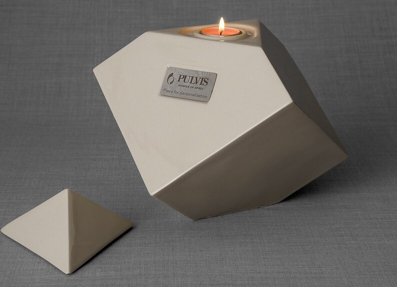 Ceramic art urn for ashes Abstract. The urn represents a cube sitting on one of its angles. The top angle pyramid is removable and there is a small place for a candle. This is a photo of all the available colors. Cube Urn for Ashes. Cube Urn