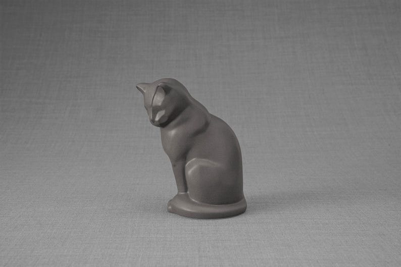 Ceramic Art Urn for Cats cremation ashes. The urn represents a cat sitting in a comfortable position with its tail around her body and its head gently looking left. Mini pet memorial urn. Pet memorial urn for ashes. Pet mini urn. Mini Urn by Pulvis