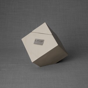 Ceramic art urn for ashes Abstract. The urn represents a cube sitting on one of its angles. The top angle pyramid is removable and there is a small place for a candle. This is a photo of all the available colors. Cube Urn for Ashes. Cube Urn