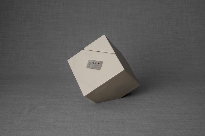Ceramic art urn for ashes Abstract. The urn represents a cube sitting on one of its angles. The top angle pyramid is removable and there is a small place for a candle. This is a photo of all the available colors. Cube Urn for Ashes. Cube Urn