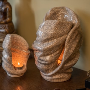 Handmade adult urn for cremation ashes Light. The urn has a place for a candle in the middle or an option for putting flowers. The capacity of 237 cubic inches. Ashes go inside the walls. This is a photo of a large urn and keepsake.