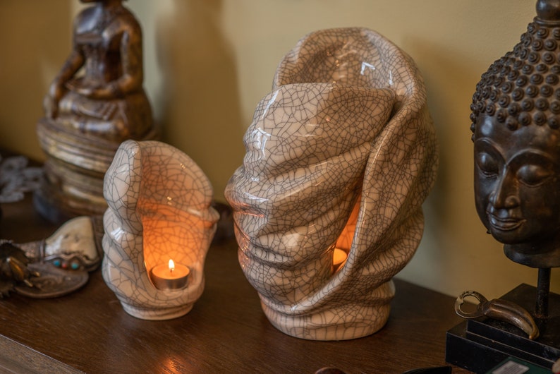 Handmade adult urn for cremation ashes Light. The urn has a place for a candle in the middle or an option for putting flowers. The capacity of 237 cubic inches. Ashes go inside the walls. This is a photo of a large urn and keepsake.