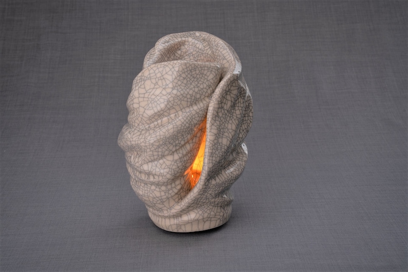 Handmade Adult Urn for Cremation ashes. The urn has a place for a candle in the middle, or option for putting flowers. Adult size urn with capacity of 237 cubic inches. Ashes go inside the walls. The color of this handmade ceramic urn is craquelure.