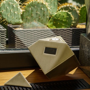 Ceramic art urn for ashes Abstract. The urn represents a cube sitting on one of its angles. The top angle pyramid is removable and there is a small place for a candle. This is a photo of all the available colors. Cube Urn for Ashes. Cube Urn