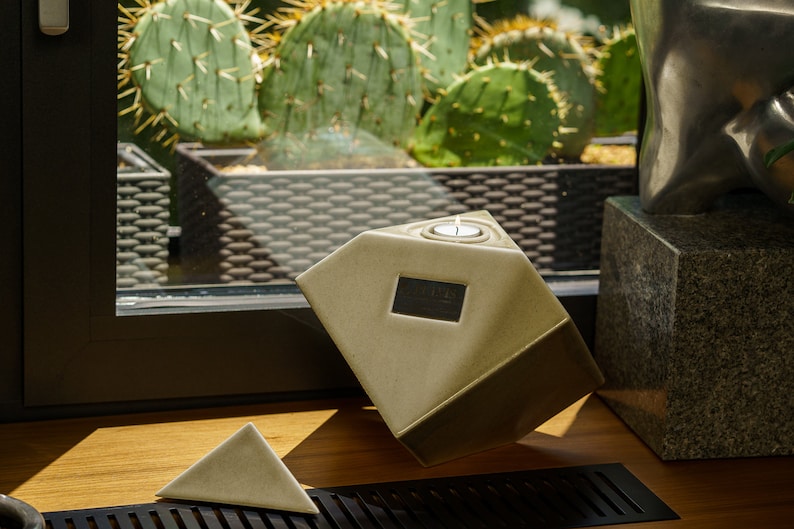 Ceramic art urn for ashes Abstract. The urn represents a cube sitting on one of its angles. The top angle pyramid is removable and there is a small place for a candle. This is a photo of all the available colors. Cube Urn for Ashes. Cube Urn