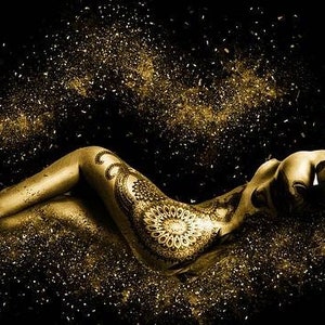 May include: A woman's body is covered in gold glitter and a detailed mandala design. The background is black with gold glitter.