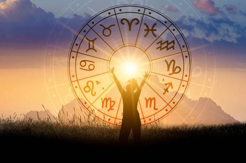 May include: Silhouette of a person with arms raised towards a bright sun, set against a backdrop of a zodiac wheel with astrological symbols. The image is set during a sunset with a warm color palette.