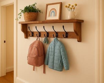 Handmade wooden wall mounted coat rack with storage shelf, featuring sturdy cast iron hooks