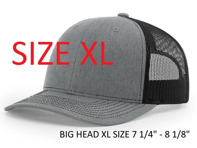 May include: A gray and black XL trucker hat with a curved brim. The front panel is gray, and the back is black mesh. The text "SIZE XL" is in red. The hat size is 7 1/4" - 8 1/8".