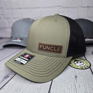 May include: A green and black trucker hat with a brown leather patch that says "FUNCLE".