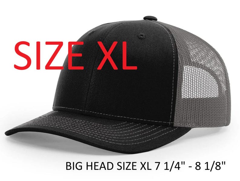 May include: Black and gray XL trucker hat with a mesh back and a curved brim. The hat has the text "SIZE XL" in red. The hat is designed for big heads, fitting sizes 7 1/4" - 8 1/8".