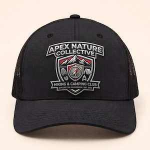 May include: A black baseball cap with a mesh back and a front patch featuring the text APEX NATURE COLLECTIVE HIKING & CAMPING CLUB EXPLORE THE WILDERNESS | EST. 2024, with a graphic of mountains, a compass, a footprint, a tent, and a campfire.