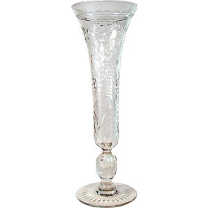 May include: A clear glass vase with a cut glass design. The vase has a round base and a tall, slender body.