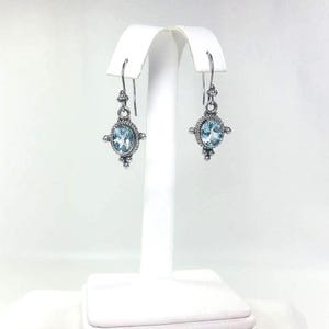 Sterling Silver handcrafted faceted blue topaz ear hook.