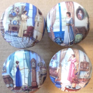 May include: Four round cabinet knobs with a vintage illustration of women in elegant dresses looking out windows. The knobs feature scenes with blue, white, and gold accents, depicting classic interior settings with furniture and decor.