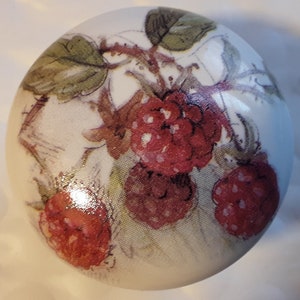 May include: White ceramic knob with a painted design of red raspberries and green leaves.