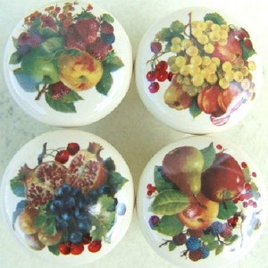 May include: Four ceramic knobs with colorful fruit designs. Each knob features a different fruit arrangement, including grapes, cherries, pomegranates, apples, and pears.