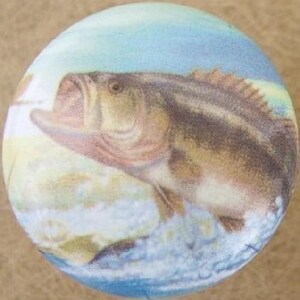 May include: A round decorative knob featuring a detailed illustration of a largemouth bass leaping from the water. The fish is depicted in shades of brown, tan, and black against a blue and white background. The knob is likely made of ceramic or porcelain.